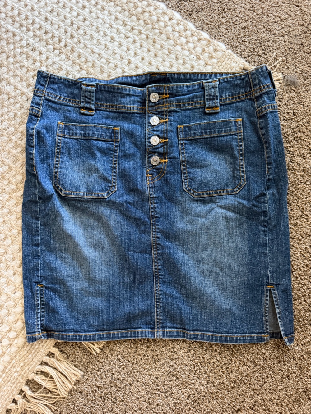 Levi's button-fly denim skirt in a medium blue wash featuring front patch pocket
